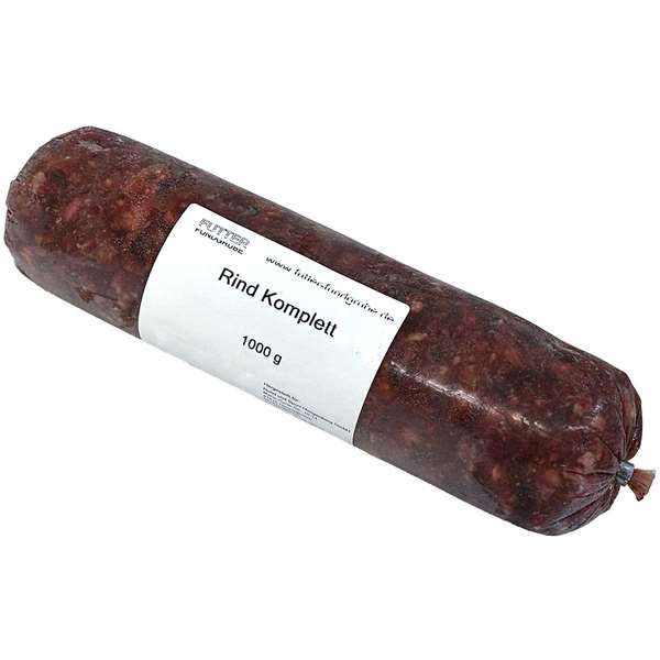 Rind Komplett im nicht essbaren Kunstdarm, vakuumverpackt als Wurstrolle mit weißem Etikett. Beschriftet mit „Rind Komplett – 1000 g“, enthält das Produkt eine vollständige Mischung aus Rinderbestandteilen zur Tierfütterung.