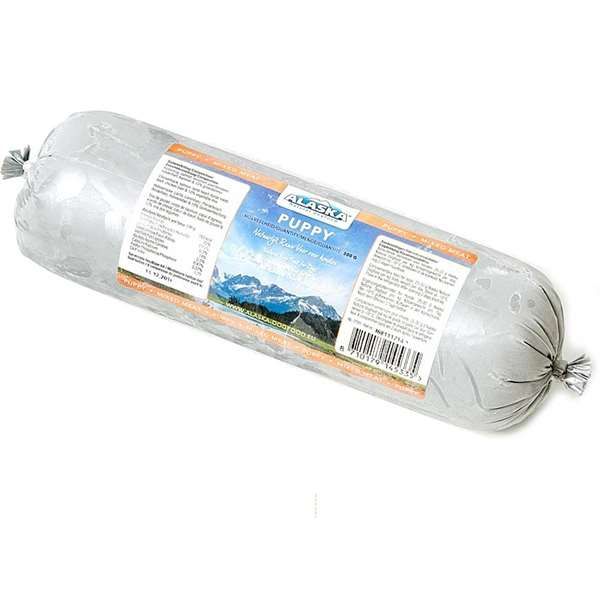 Eine Frostfleischrolle mit silbernem Kunstdarm und der Aufschrift „Puppy“. Verpackt in einem nicht essbaren Kunstdarm. Die Füllung ist nicht sichtbar.